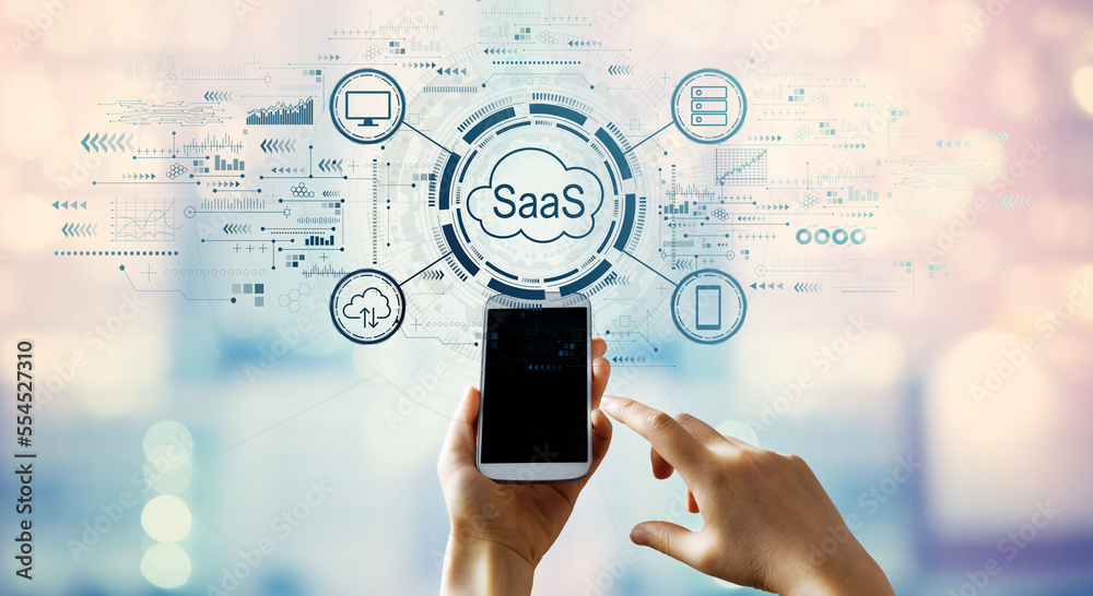 SaaS - software as a service concept with hand pressing a smartphone screen