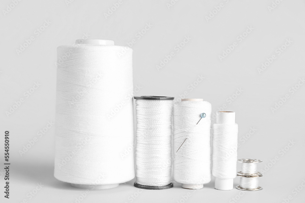 Different thread spools isolated on white background