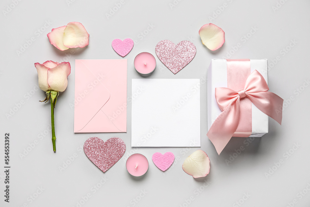 Blank letter with hearts, rose and gift on grey background. Valentines Day celebration