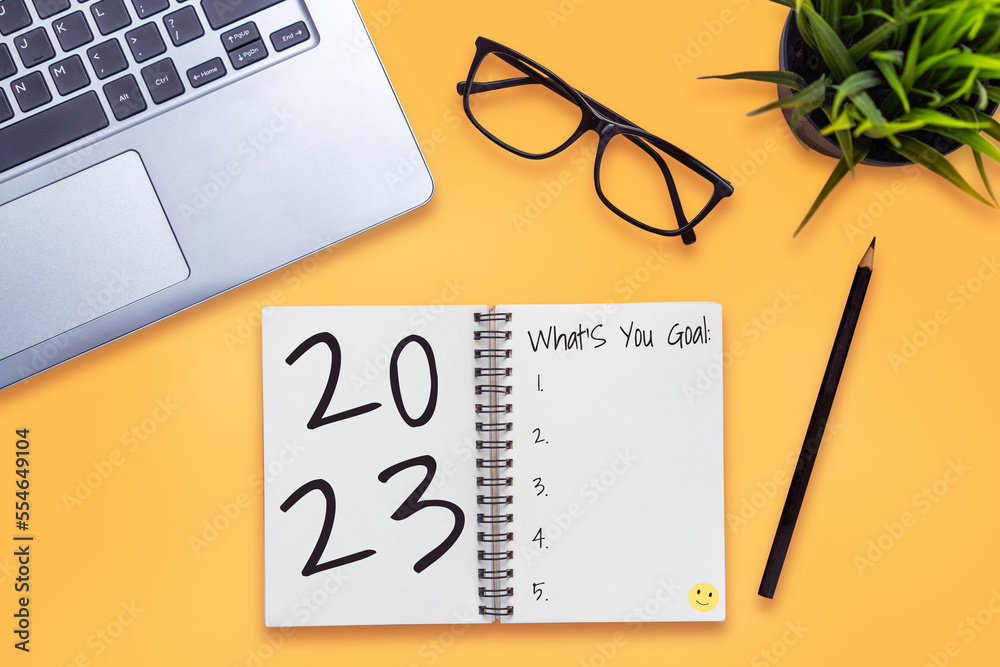 2023 Happy New Year Resolution Goal List and Plans Setting - Business office desk with notebook writ