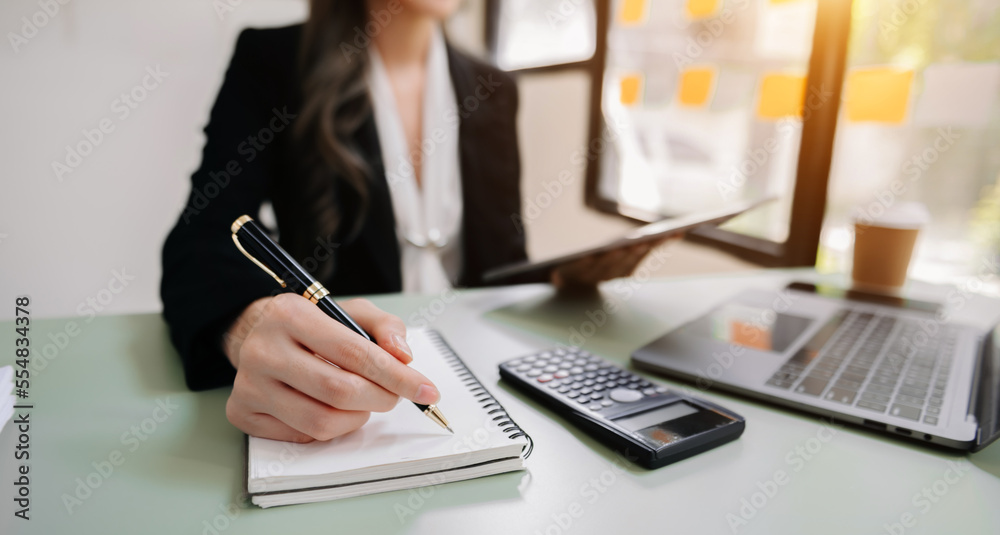 businesswoman hand working with new modern computer and writing on the notepad strategy diagram as c