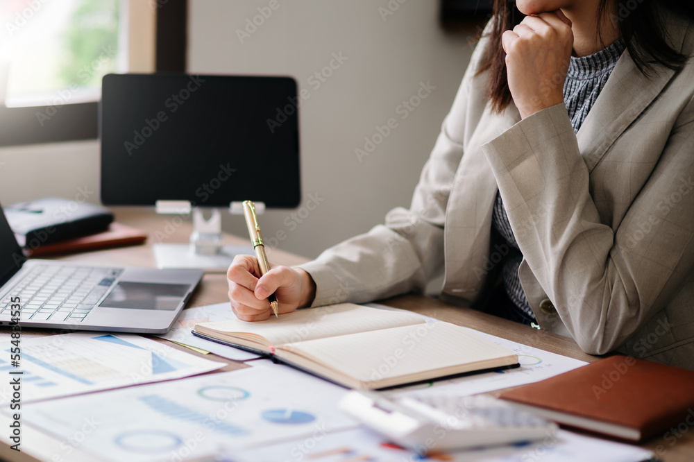 businessman hand working with new modern computer and writing on the notepad strategy diagram as con