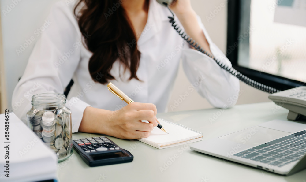 businesswoman hand working with new modern computer and writing on the notepad strategy diagram as c