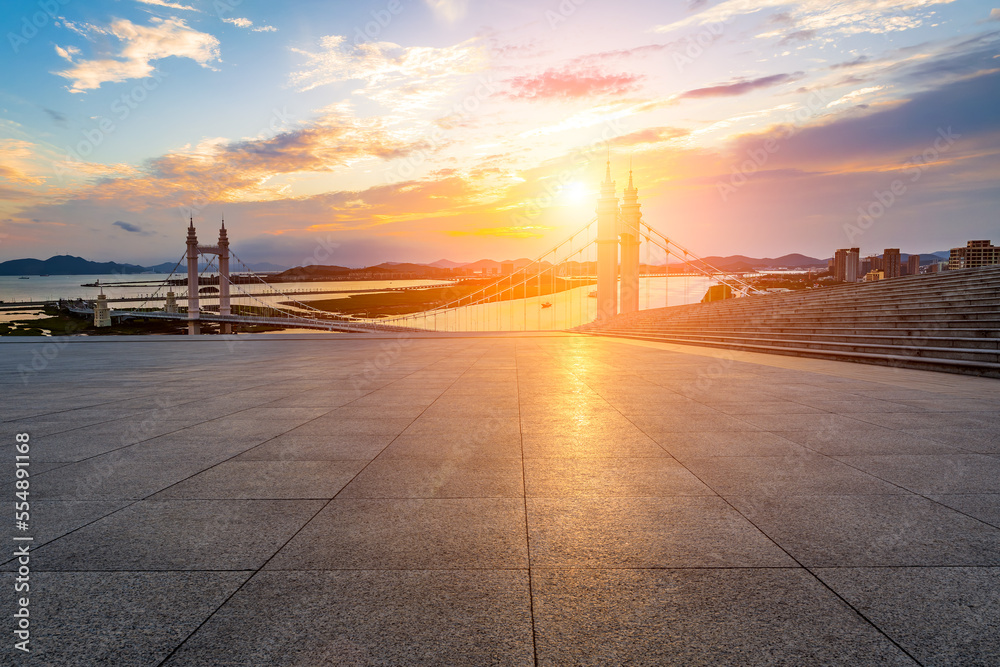 Empty square floors and bridge with river at sunset in Zhoushan, Zhejiang, China.