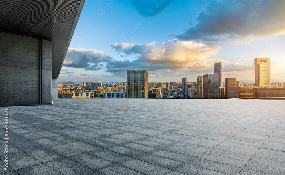 Empty square floor and modern city skyline with buildings at sunset in Ningbo, Zhejiang Province, Ch