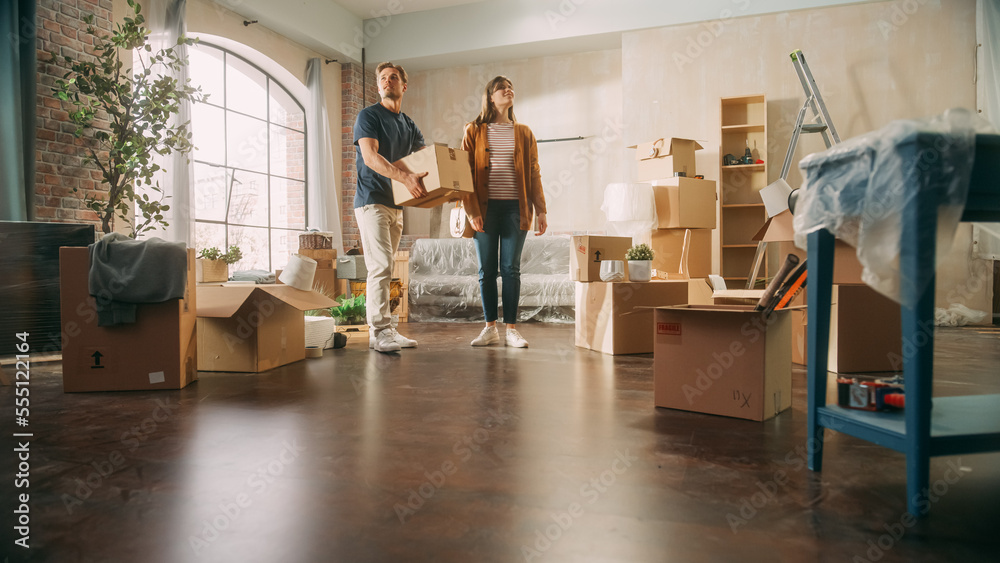 Family New Home Moving in: Happy and Excited Young Couple Enter Newly Purchased Apartment. Beautiful