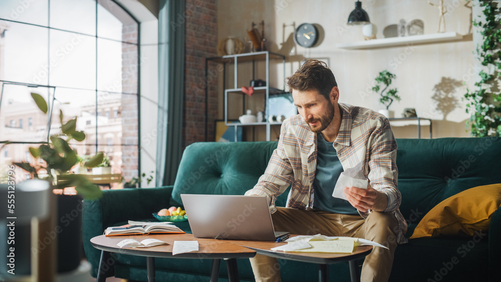 Happy Accounting at Home: Cheerful Smiling Man Using Laptop Computer, Filling Tax Forms. Businessman