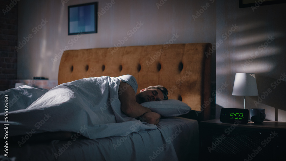 Handsome Man Wakes Up and Turns off Alarm Clock. Proceeds to Have a Productive Day of Work. Stylish 