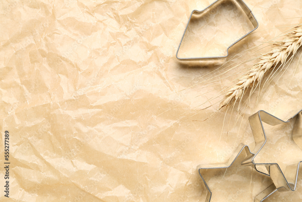 Wheat ear and cookie cutters on baking paper