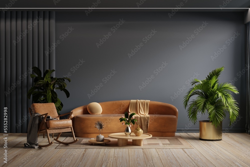 Dark room with leather sofa and leather armchair on empty dark blue wall background.