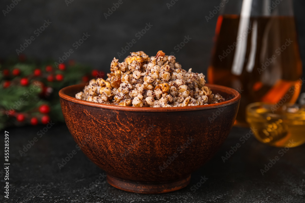 Bowl of Kutya with Christmas branch on dark background, closeup