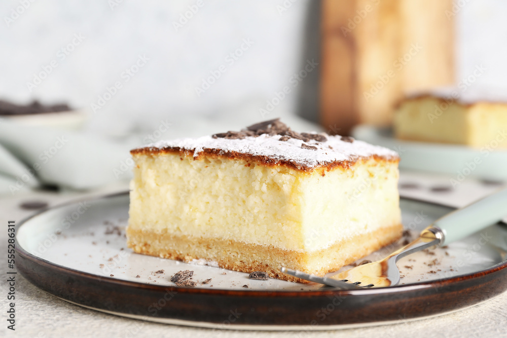 Plate with cheese pie and chocolate on white table