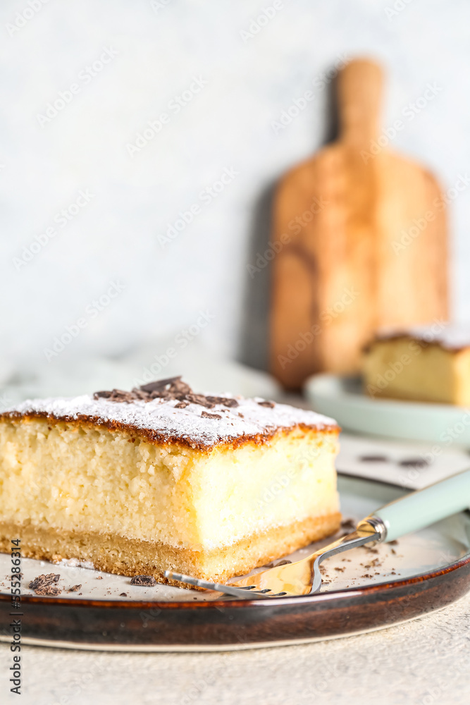 Plate with cheese pie and chocolate on white table