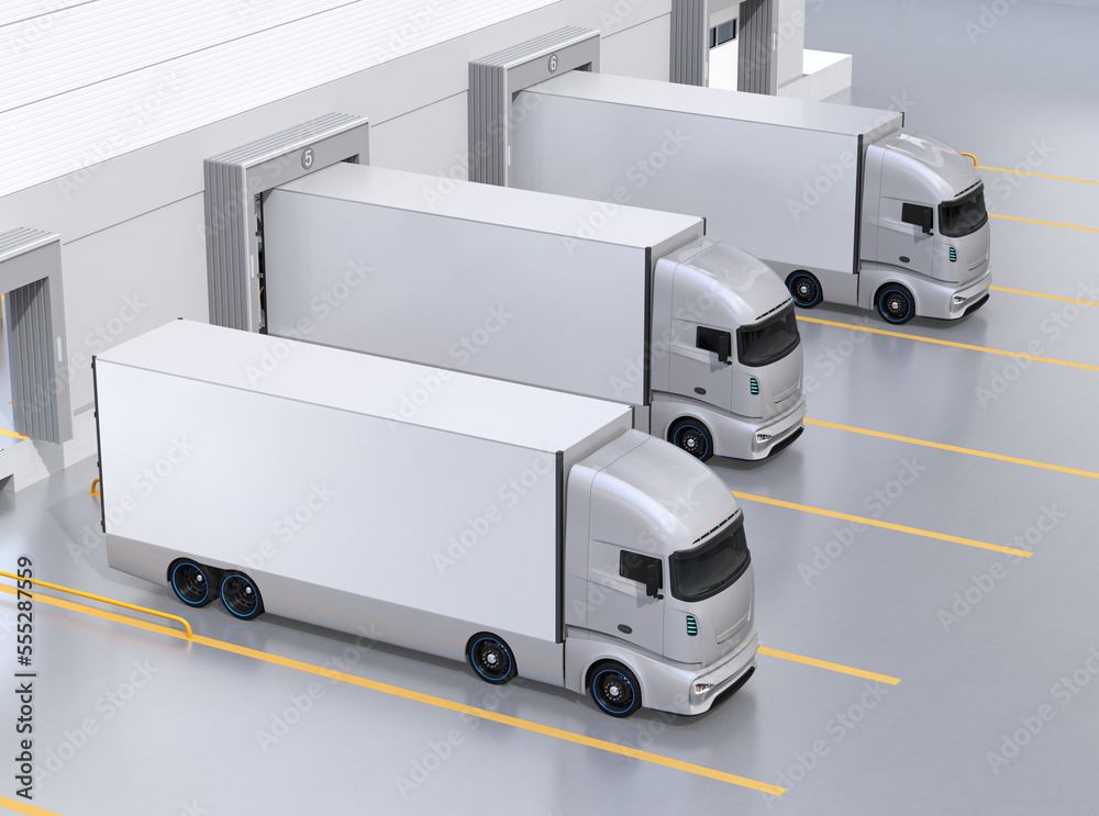 Generic design silver Electric Trucks parking at logistics center.  3D rendering image.