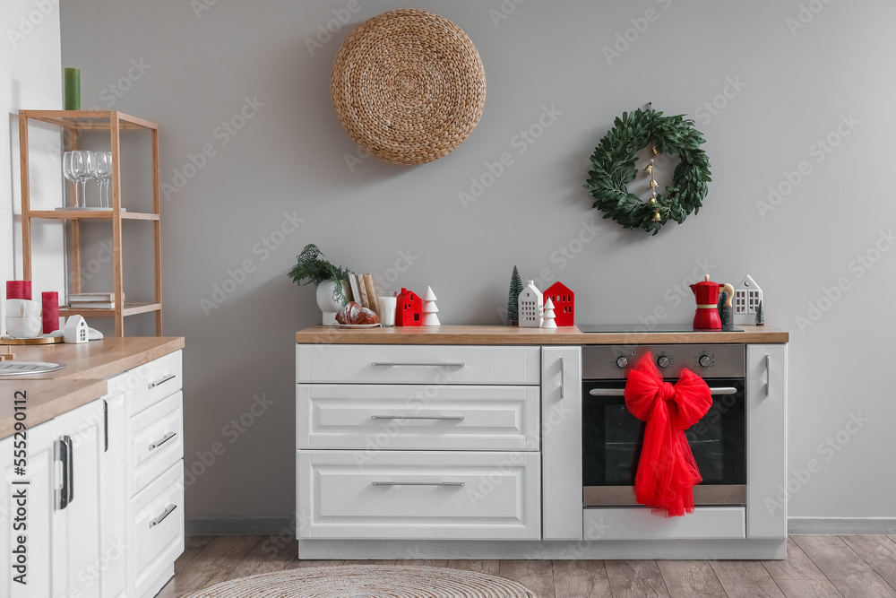 Interior of kitchen with Christmas wreath, oven and bow