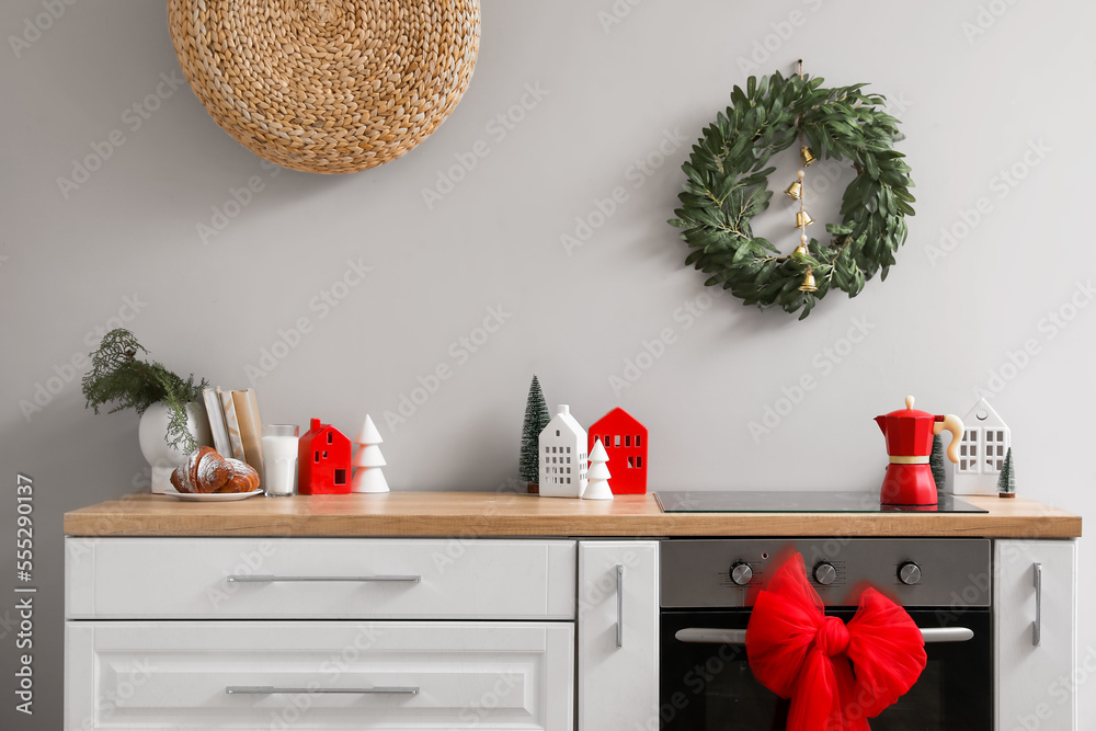 Interior of kitchen with Christmas wreath, oven and bow