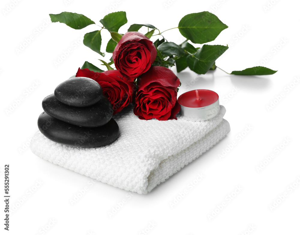 Beautiful spa composition for Valentines Day with flowers, towel, candle and stones on white backgr