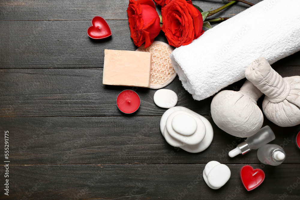 Beautiful spa composition for Valentines Day with herbal bags, towel, rose flowers, soap, stones an