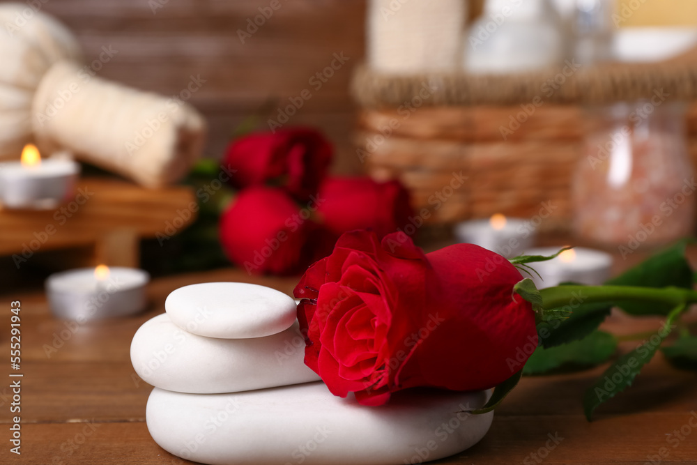 Beautiful spa composition for Valentines Day with stones and rose on wooden background