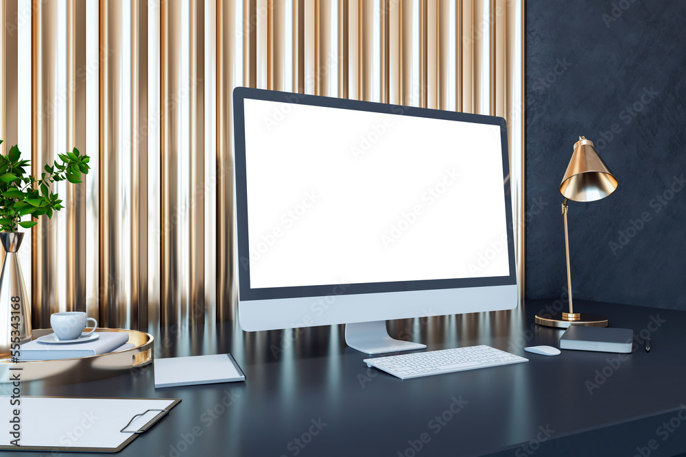 Perspective view on blank white computer monitor with empty place on dark work table with notebook, 