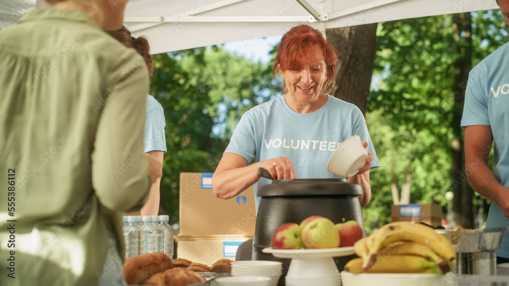 Happy Middle Age Woman Working in Community Food Bank, Serving Free Meals for People in Need. Volunt