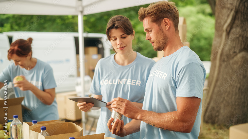 Team of Young Volunteers Helping in a Local Community Food Bank, Preparing Free Meal Rations to Low-