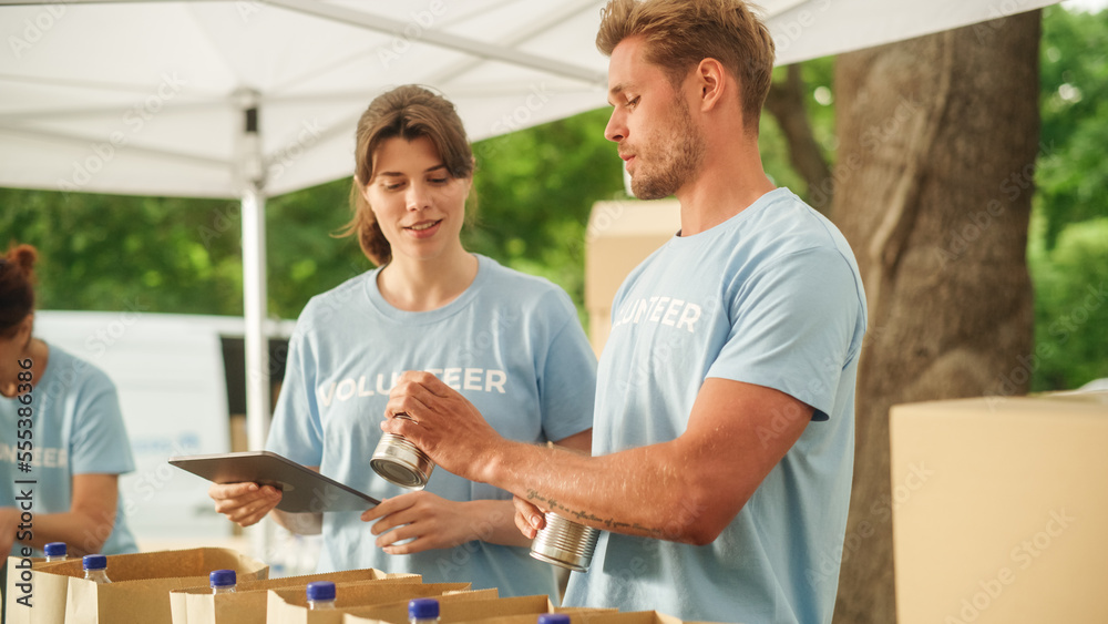 Team of Young Volunteers Helping in a Local Community Food Bank, Preparing Free Meal Rations to Low-