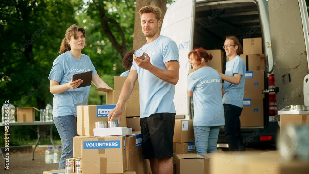 Team of Young Volunteers Preparing Humanitarian Aid Rations, Food, Donations and Loading Packages in