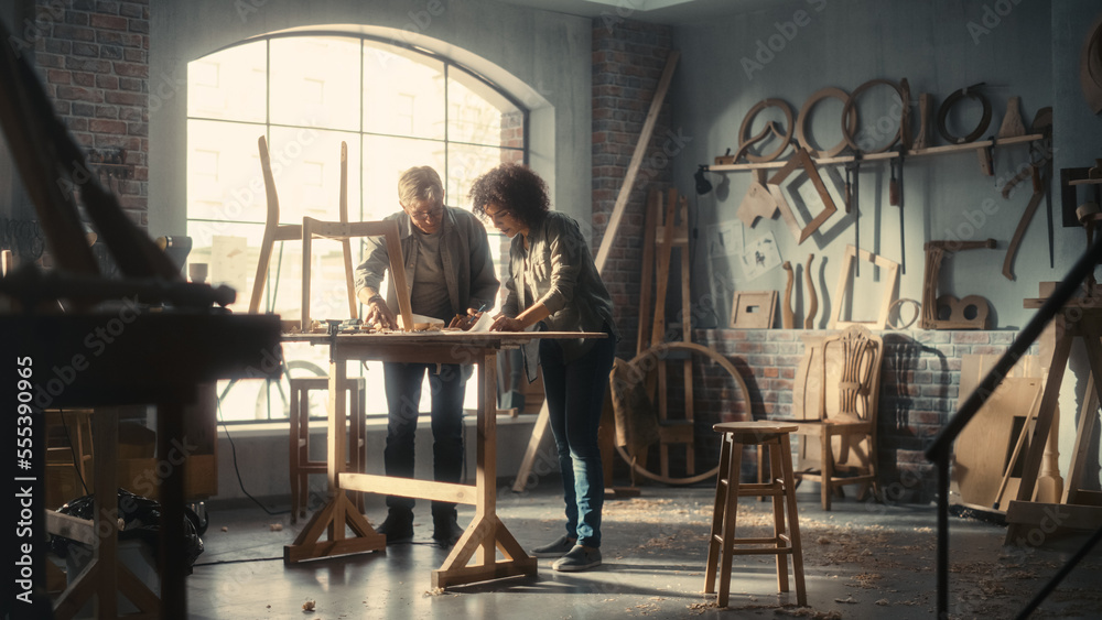 Small Business Owners of a Furniture Workshop Discussing the Design of a New Wooden Dining Table Cha