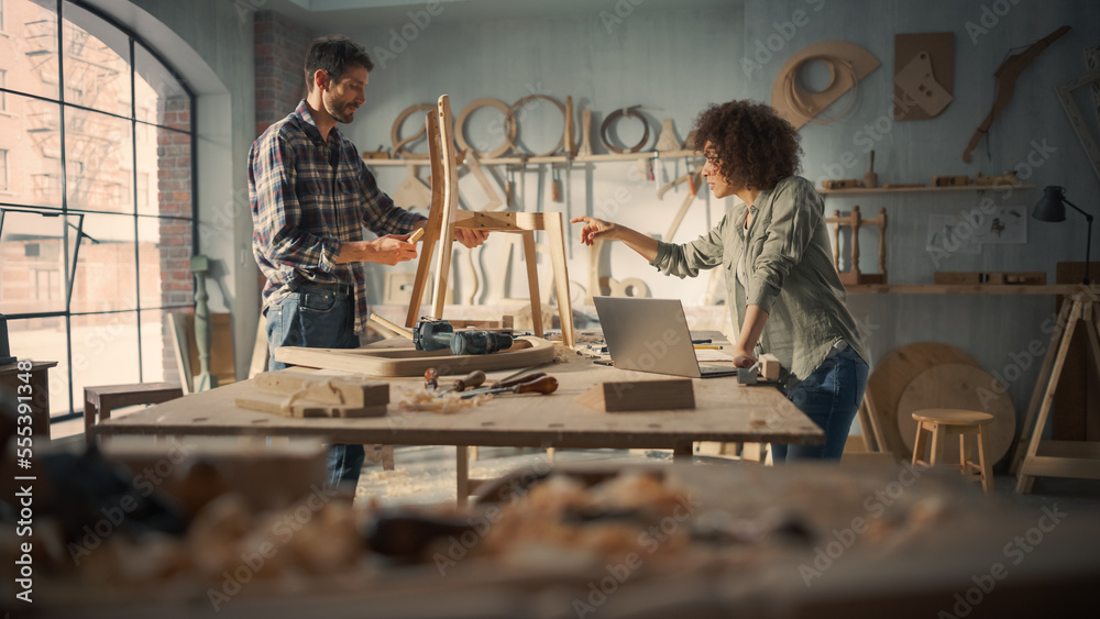 Adult Carpenter and a Young Multiethnic Female Apprentice Working in Loft Studio on a New Chair Desi