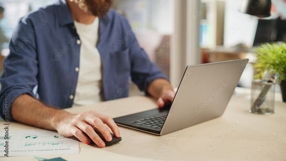 Close Up Portrait of a Handsome Long-Haired Bearded Manager Sitting at a Desk in Creative Office. St