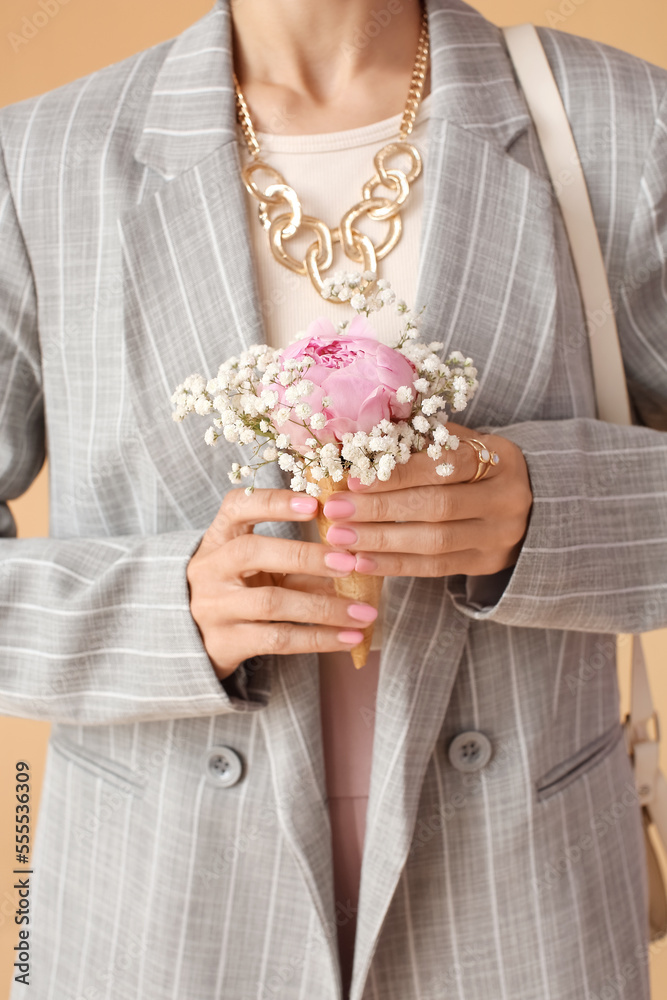 Woman with beautiful manicure and stylish jewelry holding bouquet of blooming flowers, closeup