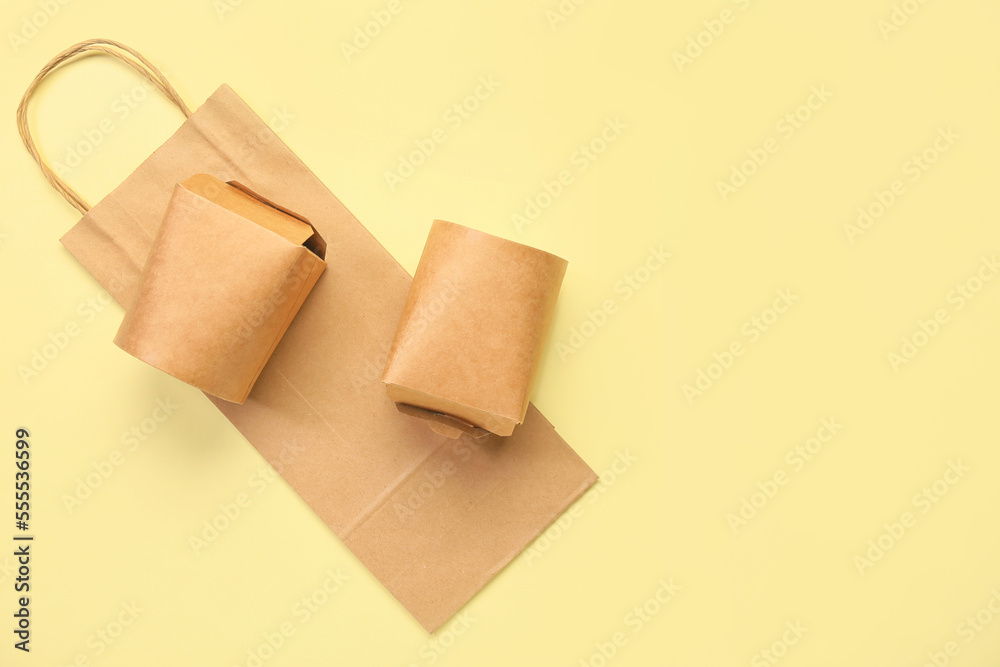 Paper boxes and bag on color background