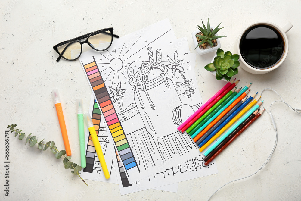 Coloring pages, felt-tip pens, pencils, flowerpots and cup of coffee on white background