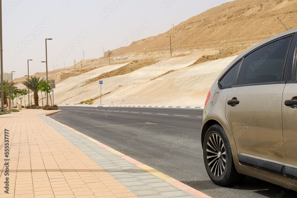 Modern car on road in desert