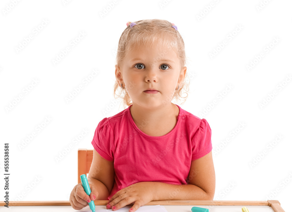 Cute little girl with felt-tip pen at table on white background