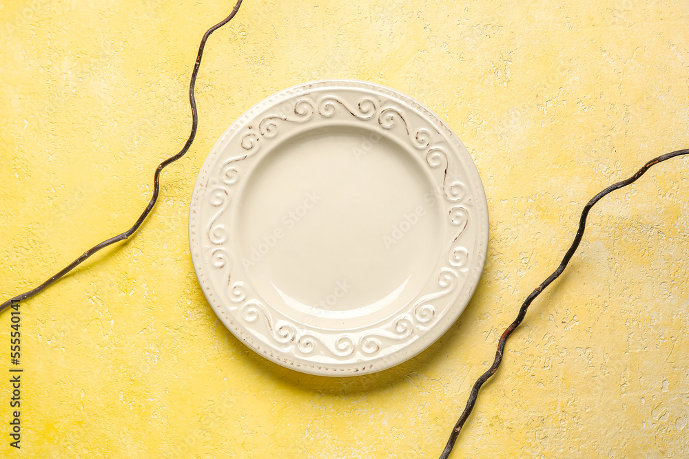 Empty vintage plate on yellow background