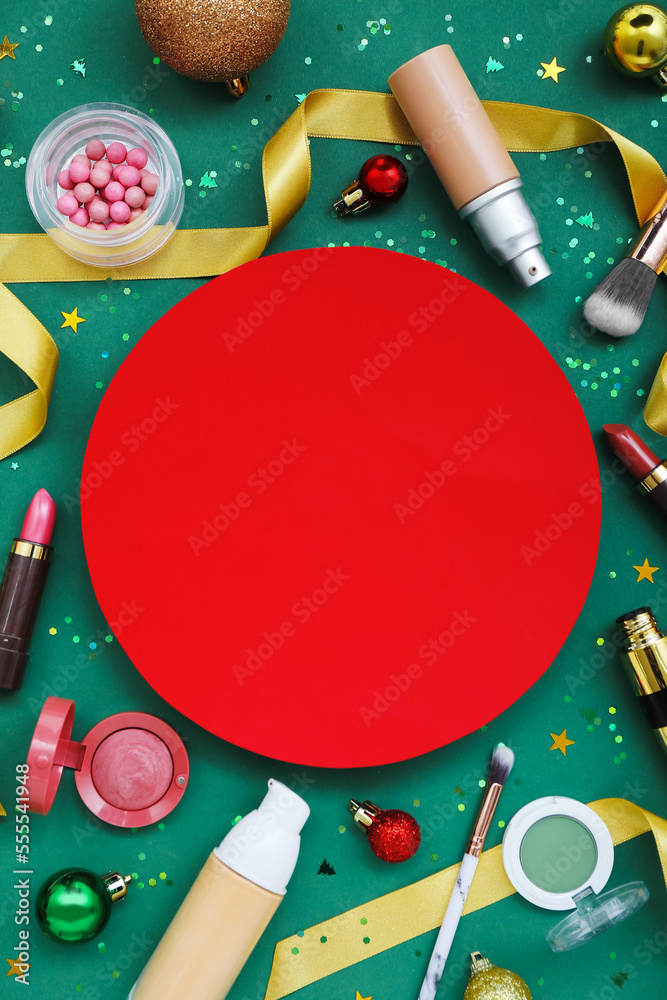 Composition with blank card, cosmetics and Christmas decorations on green background