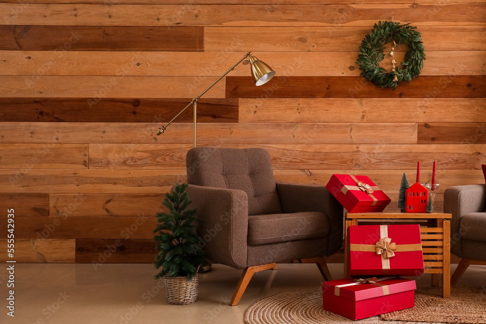 Interior of living room with Christmas wreath, armchairs and presents