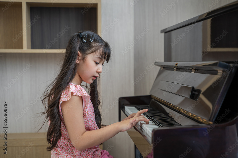 Happy child of learning the piano,Interesting music home education lesson.