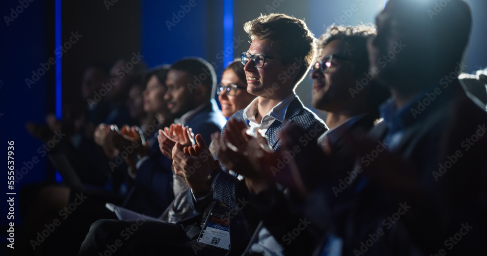 Young Male Sitting in a Crowded Audience at a Science Conference. Delegate Cheering and Applauding A