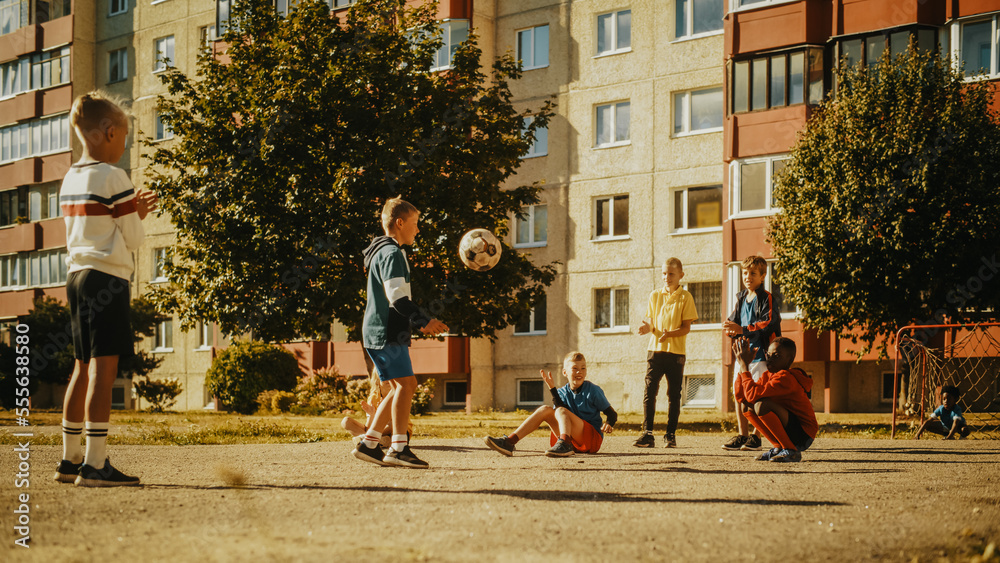 Young Multiethnic Kids Playing with Ball in the Neighborhood. Young Boy Practicing Soccer Drills, Co