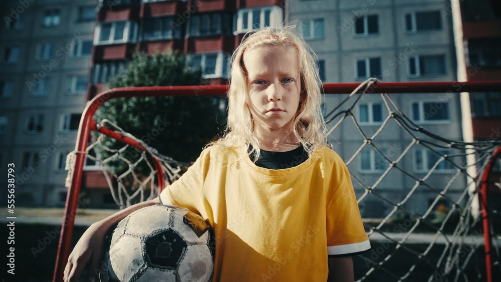 Talented Girl Playing Soccer with Neighborhood Boys. Young Football Player in Yellow T-Shirt Holding