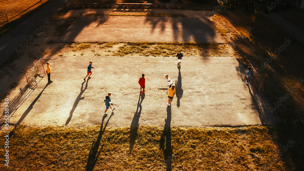 Aerial Shot of a Happy Multicultural Diverse Friends Playing Soccer in Their Backyard on a Sunny Day