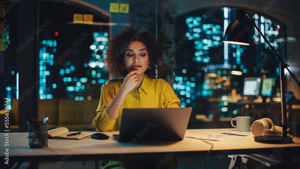 Portrait of a Happy Middle Eastern Manager Sitting at a Desk in Creative Office. Stylish Female with