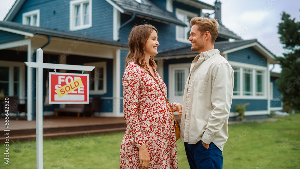 Portrait of a Beautiful Young Couple in Love Standing in Front Their New Home. Successful Homeowners