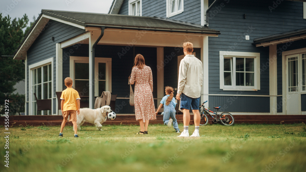 Happy Young Couple with Kids, Playing Football with a Sporty White Golden Retriever. Cheerful People