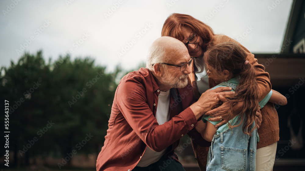 Grandfather and Grandmother are Happy to Meet Their Granddaughter in Front of their Suburbs House. G