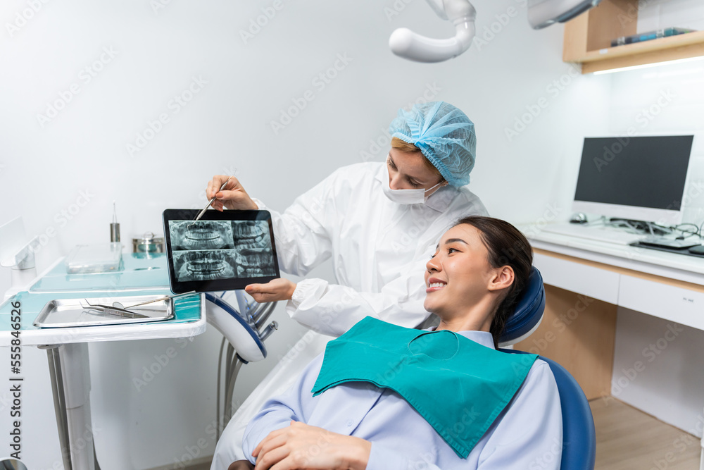 Caucasian dentist examine tooth for young girl at dental health clinic. 