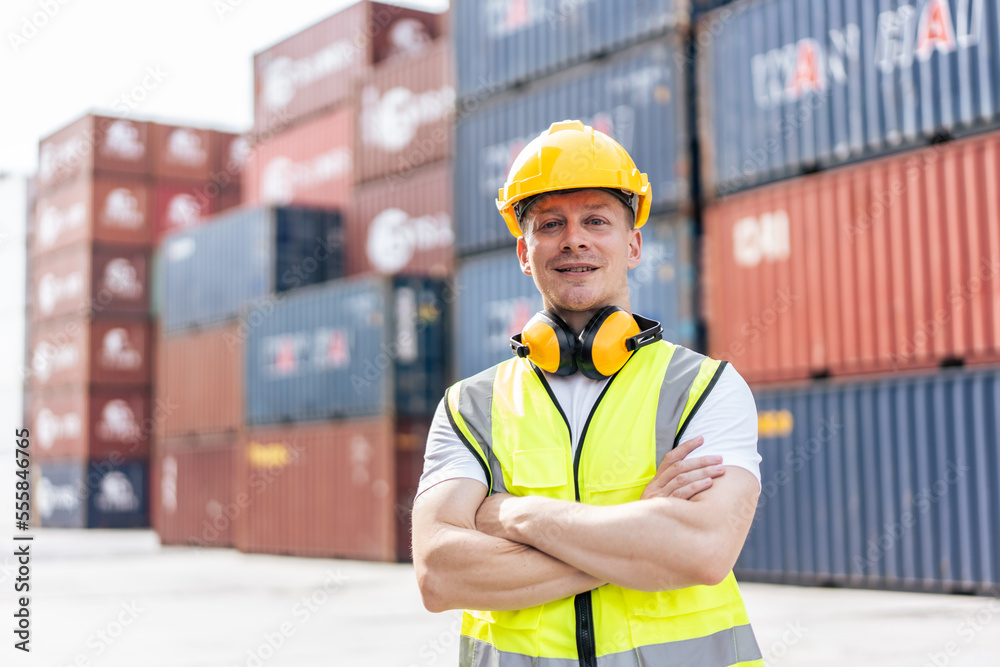 Portrait of Caucasian engineer worker work in container port terminal. 